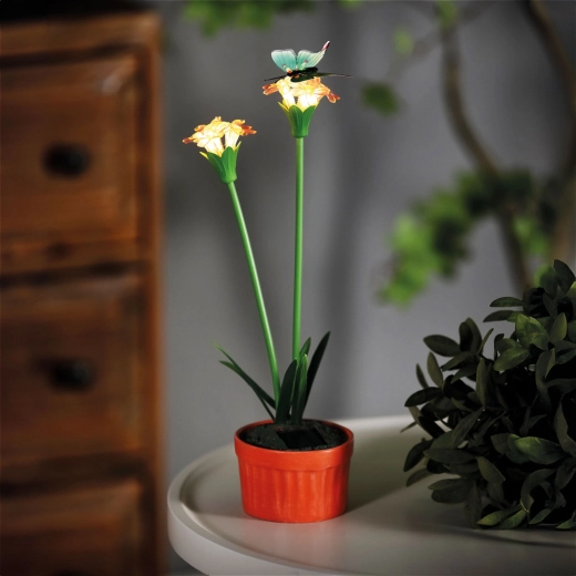 Flor solar decorativa de color rojo con iluminación LED blanca cálida